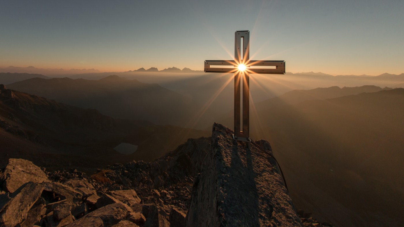 cross with sun at sunrise